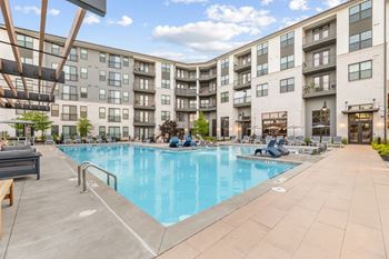 Resort-style saltwater swimming pool with tanning ledges and sundeck